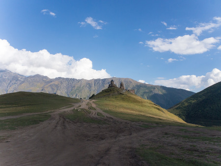 Mountain road to Gergeti Trinity Church in Caucasusの写真素材