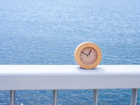 A clock against the seaの写真素材