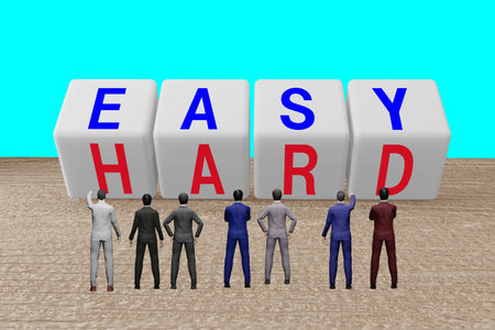 Businessman looking at EASY and HARD character blocksの写真素材