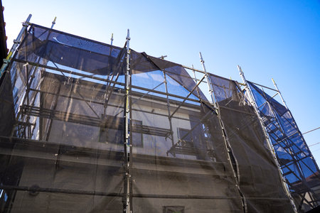 Scaffolding on a building site with blue sky in the backgroundの写真素材