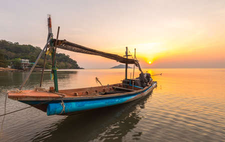 A small boat in sunset time at Ao Yang Beach,Chanthaburi,Thailandの写真素材