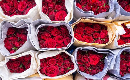 Collection of several bouquets of fresh red rose flowers in a flower marketの写真素材