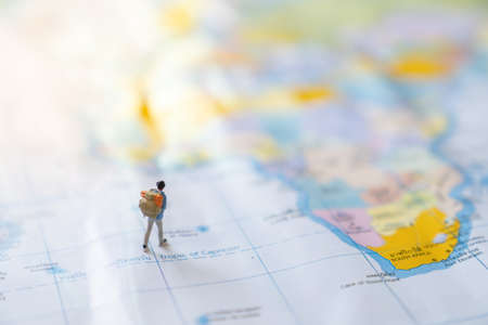 Miniature figure of a traveler with a backpack on the world map, map in Thai.の写真素材