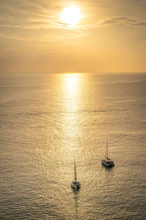 Boat on the andaman sea at sunset in Phuket, south of Thailandの写真素材