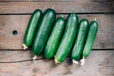 tasty organic cucumbers on a wooden boardの写真素材