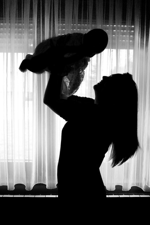 Silhouette of mother and babyの写真素材