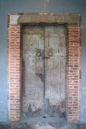 Steel door with brick wall frameの写真素材