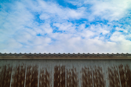 Rusty roof top with blue skyの写真素材
