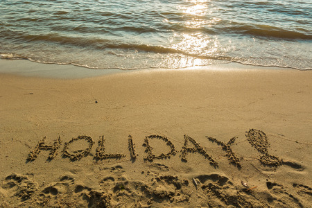 Beautiful sea cost with the inscription "holiday!"の写真素材