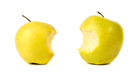 Bitten yellow green apples isolatedの写真素材