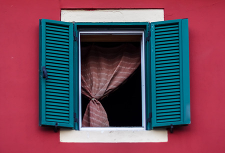 Green window on red building