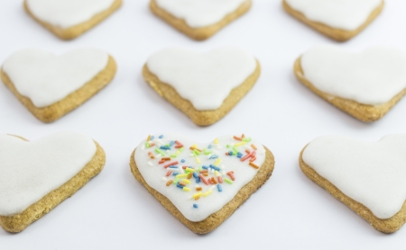 A heart shaped cookie with colorful sweets の写真素材