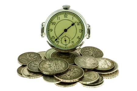 Old coins and pocket watch on a white background.の写真素材