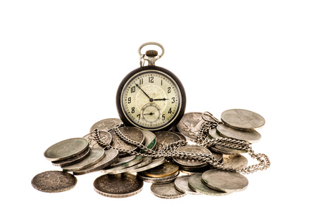 Old coins and pocket watch on a white background.の写真素材