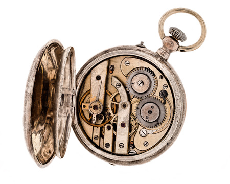 Vintage pocket watch with open rear lid isolated on white background.