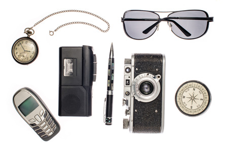 Objects for travel isolated on white background: compass, camera, tape recorder, glasses, pocket watch, phone, pen.の写真素材