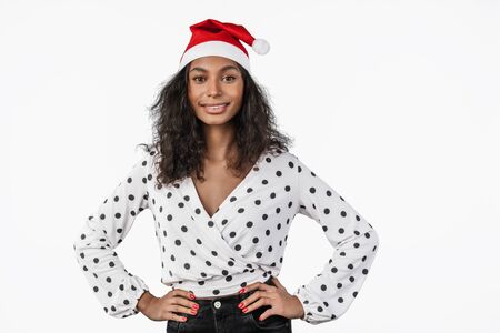 Portrait of happy african american woman in santa claus hat isolated on whiteの写真素材