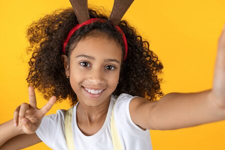 Happy young girl making selfie. Merry Christmas and New Year concept