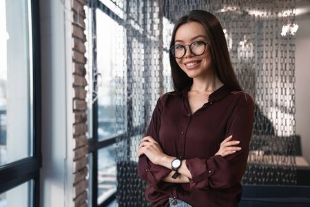 Horizontal shot of attractive business woman in casuals at coworking
