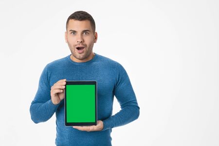 Emotional man showing digital tablet while being excited isolated on white background