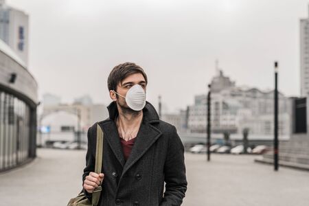Young adult man wearing hygienic mask to prevent virus. Environmental conceptの写真素材