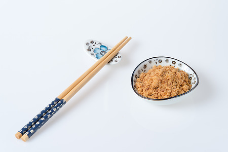 pork floss in the plate with chopsticks on white backgroundの写真素材