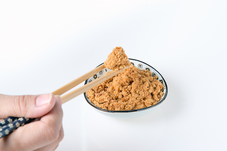 pork floss in the plate with chopsticks on white backgroundの写真素材