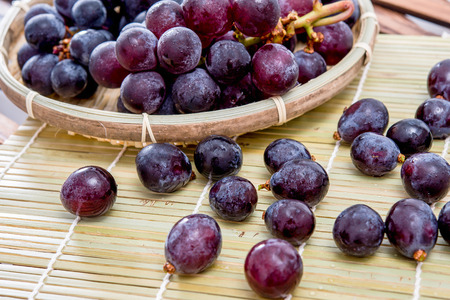 Grape in basket on wooden table