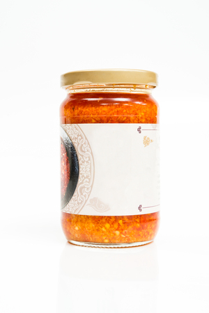 Spicy red sauce in a bottle isolated on white backgroundの写真素材