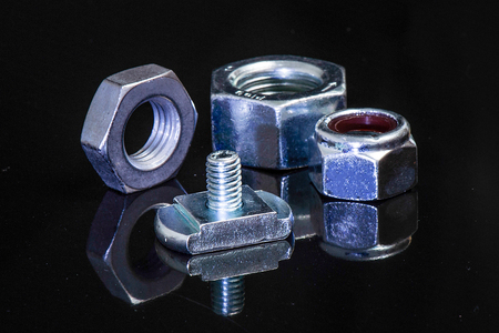 metal bolts and nut isolated on black backgroundの写真素材