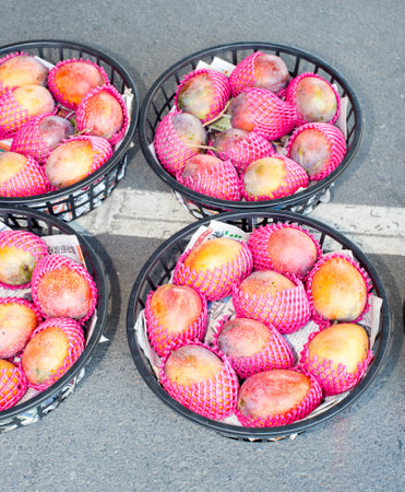 Taiwan, Tainan- May 28: several baskets of mango in a fruit market in Tainanのeditorial素材