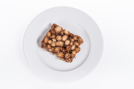 peanut candy on the plate isolated on white backgroundの写真素材