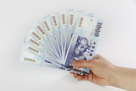new taiwan dollar fan with a handの写真素材
