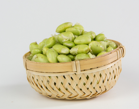 Green soybeans in a bamboo basket isolated on white backgroundの写真素材