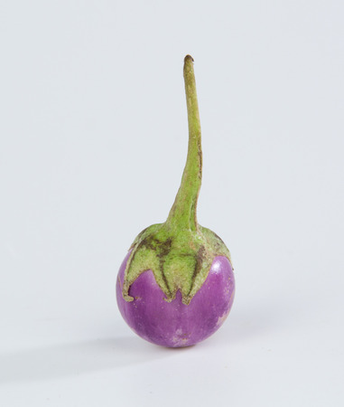 Pearl eggplant in a bamboo basket isolated on white backgroundの写真素材