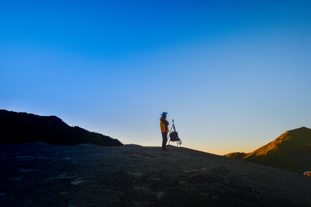 Taiwan, Hehuan mountain - October 21th. 2017: silhouette of photographer on top of mountain at sunset backgroundのeditorial素材