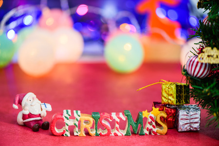 Christmas letter decoration with santa claus and presents on bokeh lightの写真素材