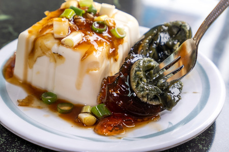 Taiwan's distinctive famous snacks: thousand-year-old eggs tofu(pidan tofu) in a white plate on stone table, Taiwan Delicacies, Taiwan Street Foodの写真素材