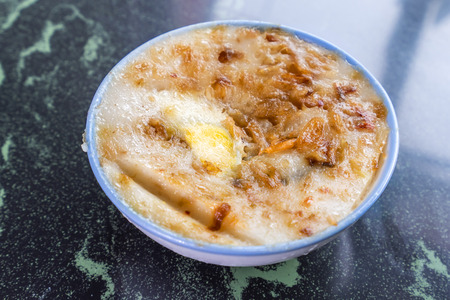 Taiwan's distinctive famous snacks: Savory rice pudding (Wa gui) in a white bowl on stone table, Taiwan Delicacies, Taiwan Street Foodの写真素材