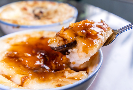 Taiwan's distinctive famous snacks: Savory rice pudding (Wa gui) in a white bowl on stone table, Taiwan Delicacies, Taiwan Street Foodの写真素材