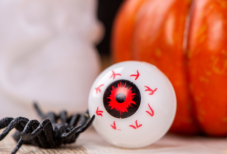 Funny halloween treats, eyeball in egg on wooden background, copy space, closeupの写真素材