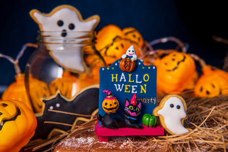 Fresh homemade decorated halloween cookies on dark background with copy space, top viewの写真素材