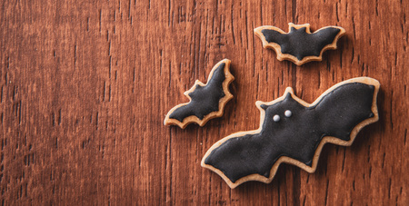 Fresh delicious homemade decorated halloween cookies sweets on dark wooden background, concept of halloween party, copy space(text space), top view, blank for text.の写真素材