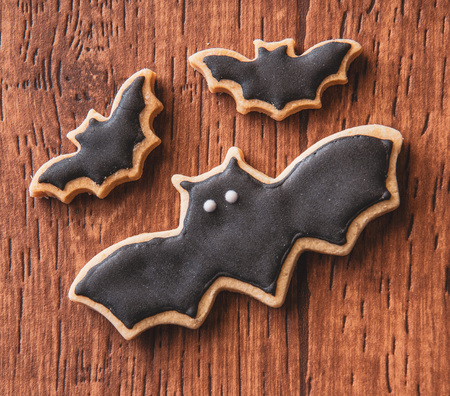 Fresh delicious homemade decorated halloween cookies sweets on dark wooden background, concept of halloween party, copy space(text space), top view, blank for text.の写真素材