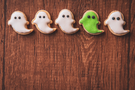 Fresh delicious homemade decorated halloween cookies sweets on dark wooden background, concept of halloween party, copy space(text space), top view, blank for text.の写真素材
