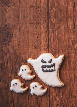 Fresh delicious homemade decorated halloween cookies sweets on dark wooden background, concept of halloween party, copy space(text space), top view, blank for text.の写真素材