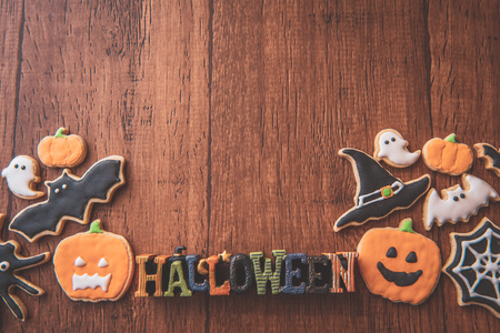 Fresh delicious homemade decorated halloween cookies sweets on dark wooden background, concept of halloween party, copy space(text space), top view, blank for text.の写真素材