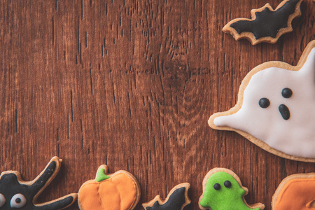 Fresh delicious homemade decorated halloween cookies sweets on dark wooden background, concept of halloween party, copy space(text space), top view, blank for text.の写真素材