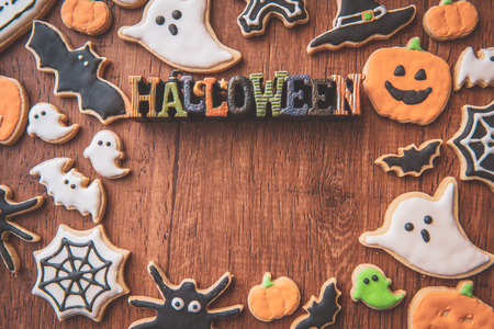 Fresh delicious homemade decorated halloween cookies sweets on dark wooden background, concept of halloween party, copy space(text space), top view, blank for text.の写真素材