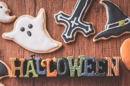 Fresh delicious homemade decorated halloween cookies sweets on dark wooden background, concept of halloween party, copy space(text space), top view, blank for text.の写真素材